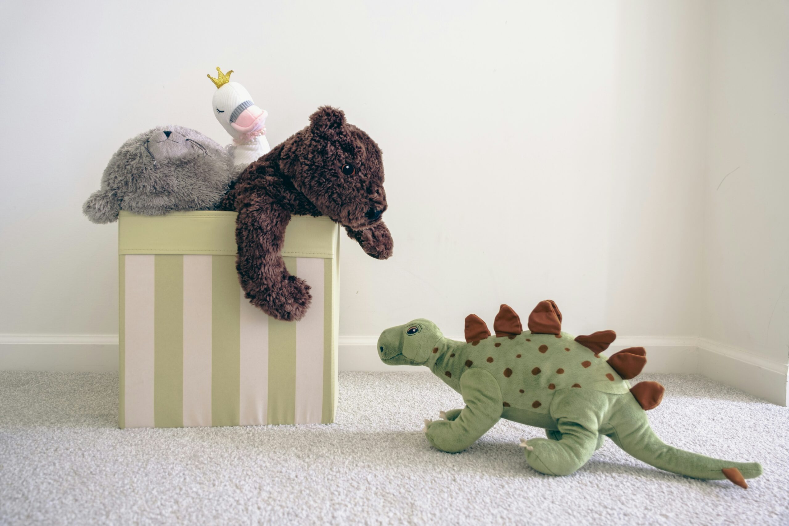 two stuffed animals sitting on top of a box